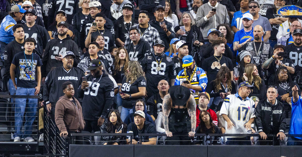 Raiders fans are dejected as the Los Angeles Chargers score again during the second half of the ...