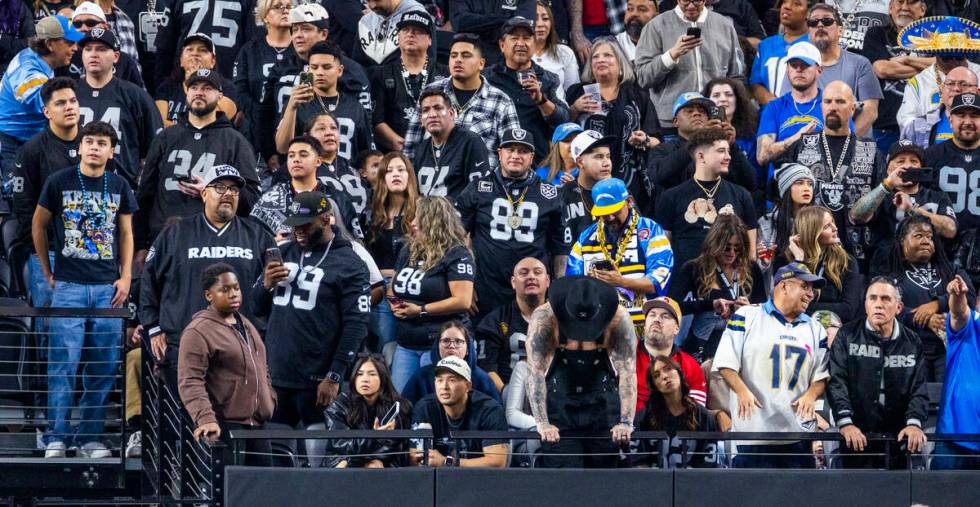 Raiders fans are dejected as the Los Angeles Chargers score again during the second half of the ...