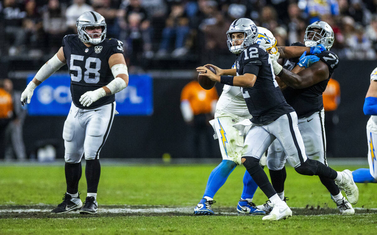 Raiders quarterback Aidan O'Connell (12) looks for a receiver against the Los Angeles Chargers ...