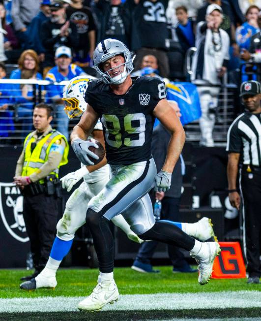 Raiders tight end Brock Bowers (89) run into the end zone past Los Angeles Chargers linebacker ...