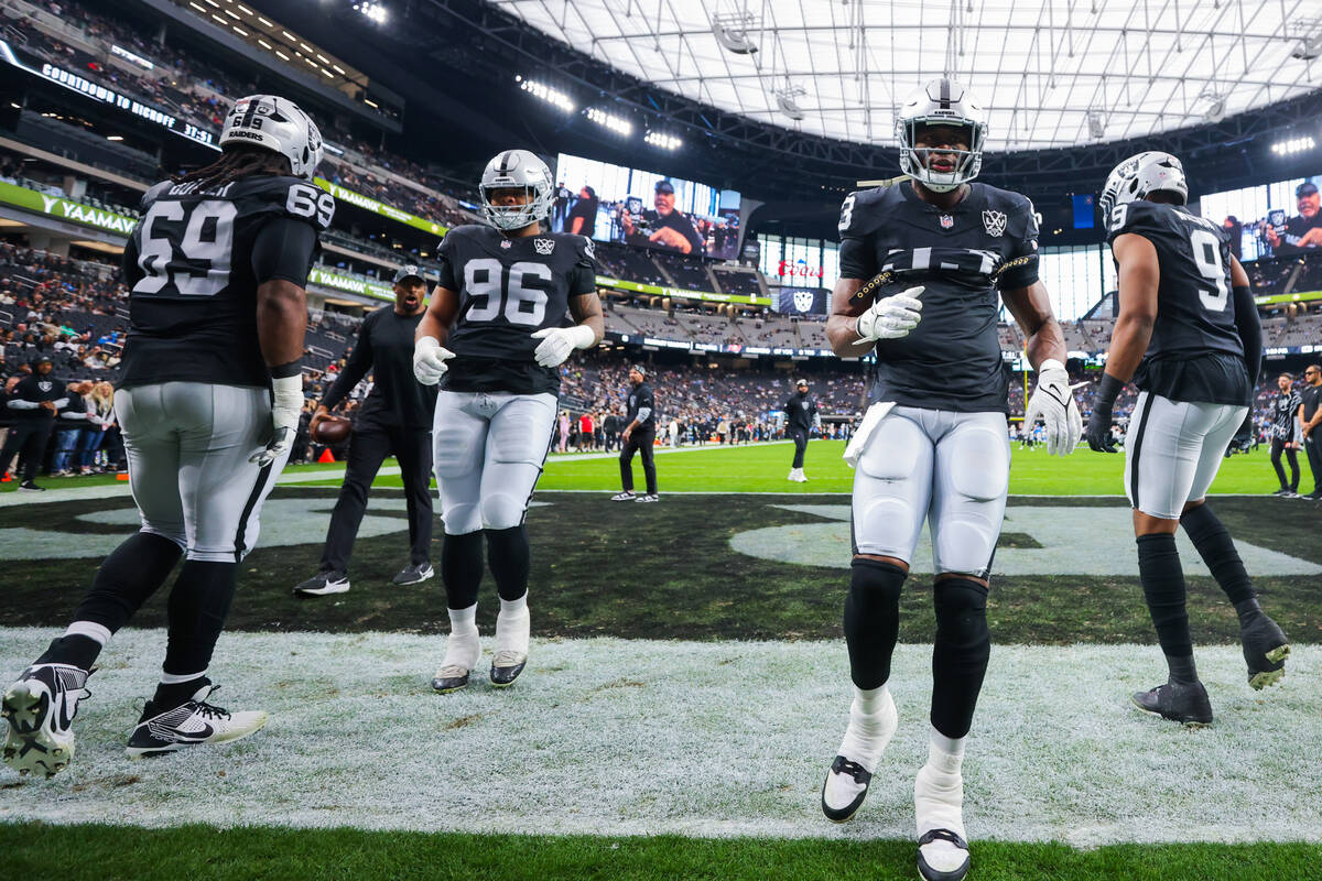 Raiders players warm up before an NFL football game between the Raiders and Los Angeles Charger ...