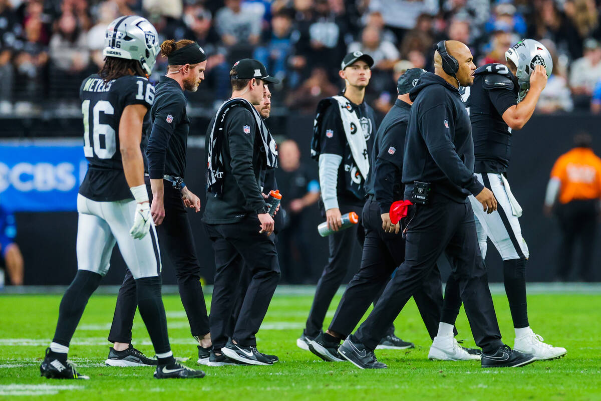 Raiders quarterback Aidan O'Connell (12) walks to the sidelines after an injury during an NFL f ...