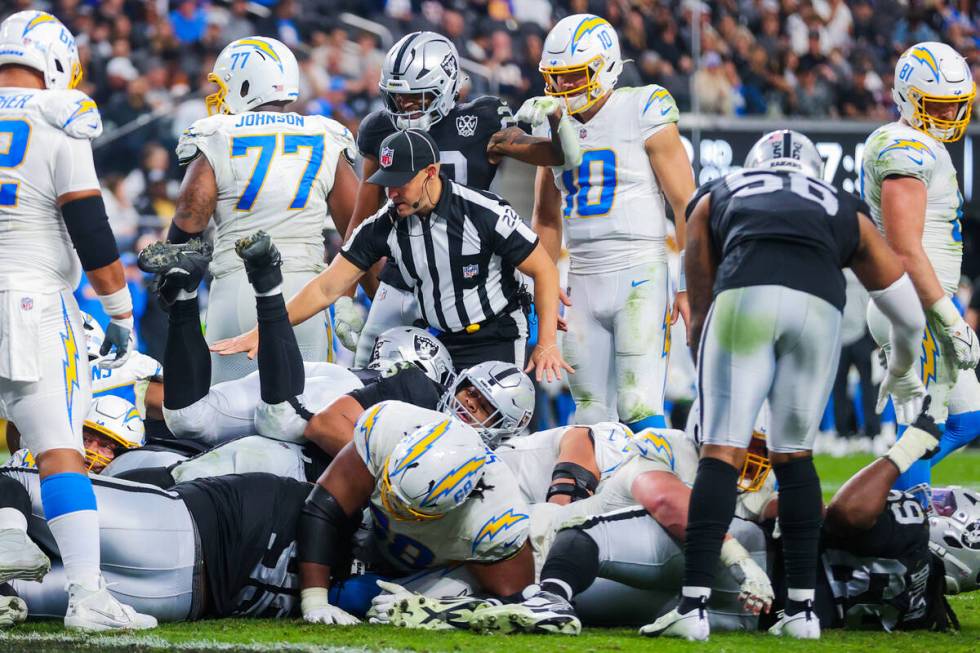 A reface blows his whistle during an NFL football game between the Raiders and Los Angeles Char ...