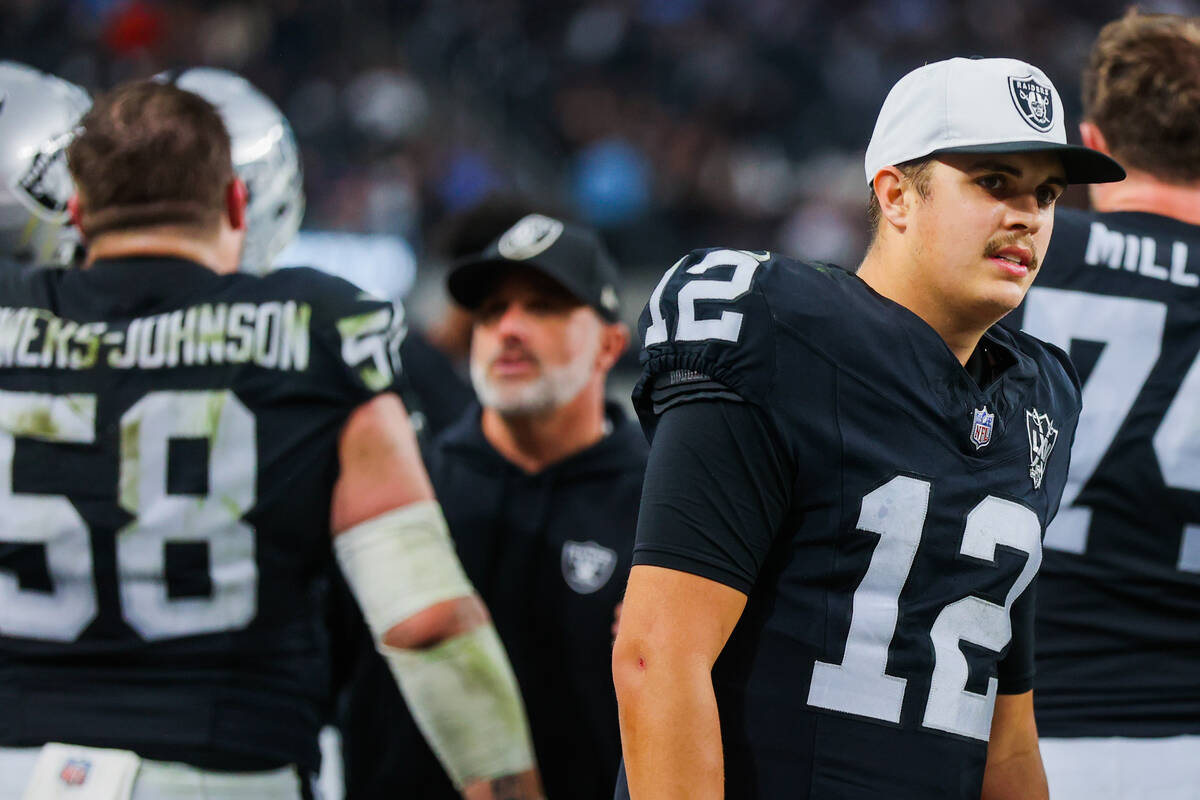 Raiders quarterback Aidan O'Connell (12) is seen on the sidelines during an NFL football game b ...