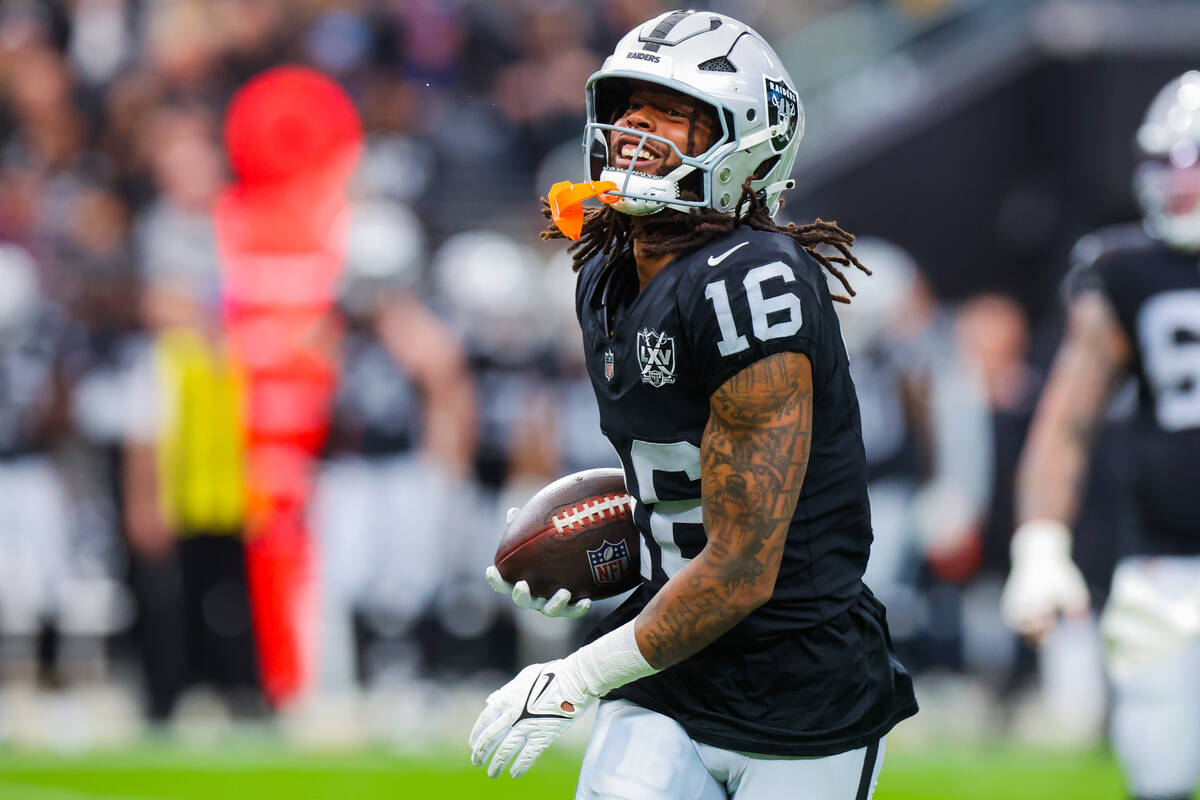 Raiders wide receiver Jakobi Meyers (16) smiles as he holds the ball during an NFL football gam ...