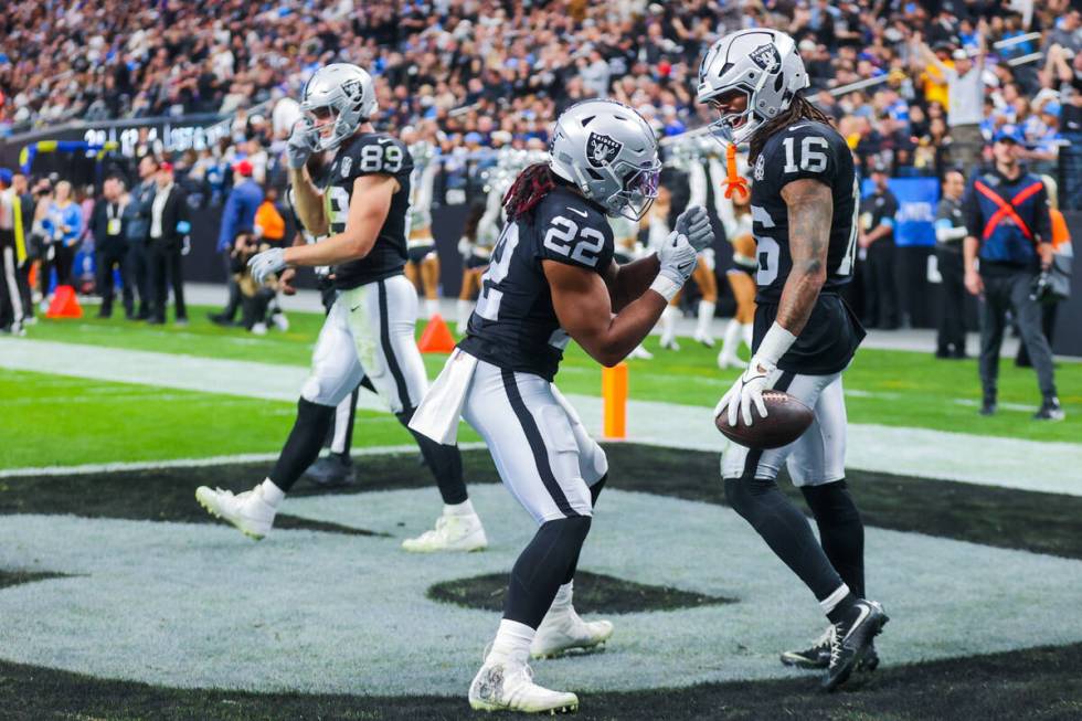 Raiders wide receiver Jakobi Meyers (16) and Raiders running back Alexander Mattison (22) celeb ...