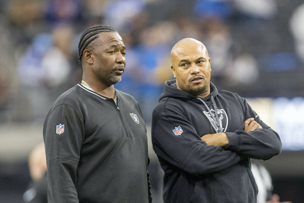 Raiders defensive coordinator Patrick Graham, left, speaks to head coach Antonio Pierce before ...