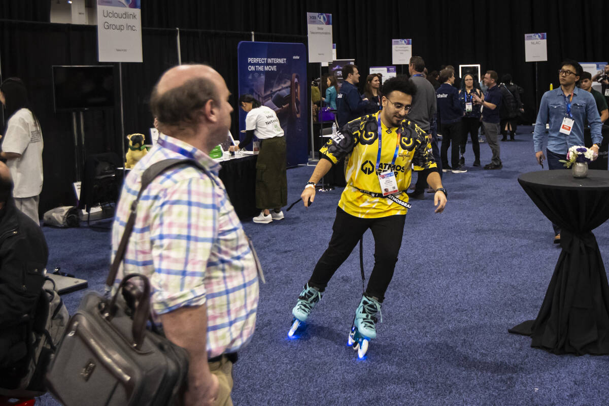 Mido Soliman, who founded AtmosGear, shows off the company's electric skates during CES Unveile ...