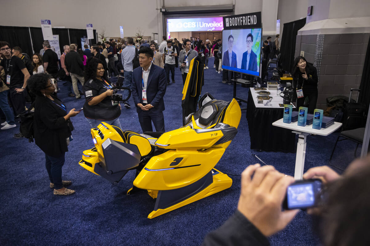 People check out the 733 massage chair by Bodyfriend during CES Unveiled on the first media day ...