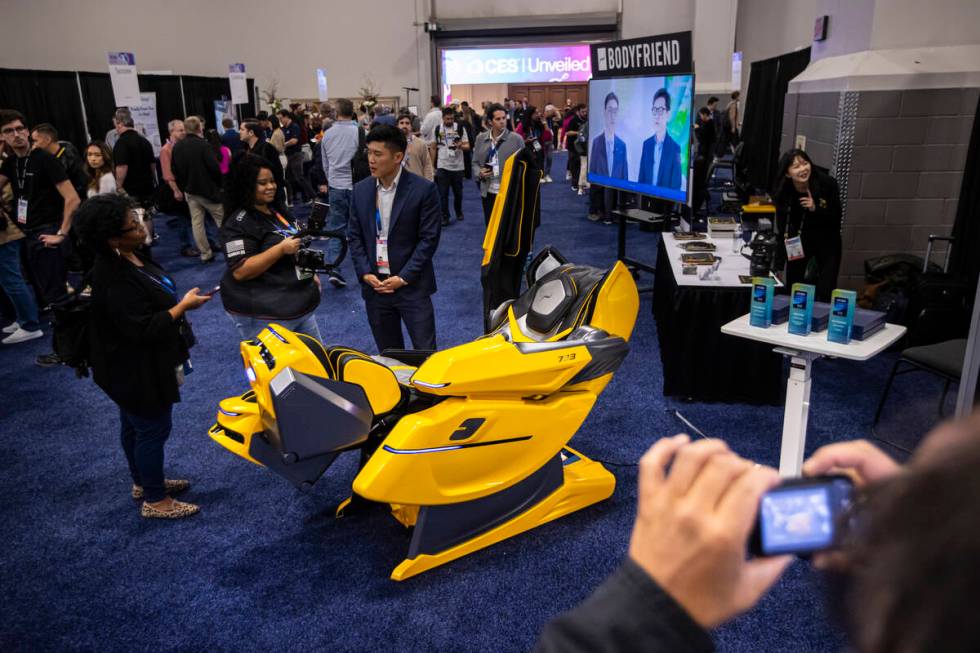 People check out the 733 massage chair by Bodyfriend during CES Unveiled on the first media day ...