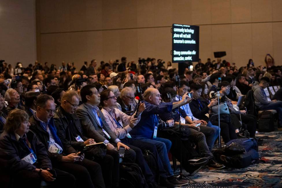 People watch and record the CES Tech Trends presentation on the first media day of the annual i ...