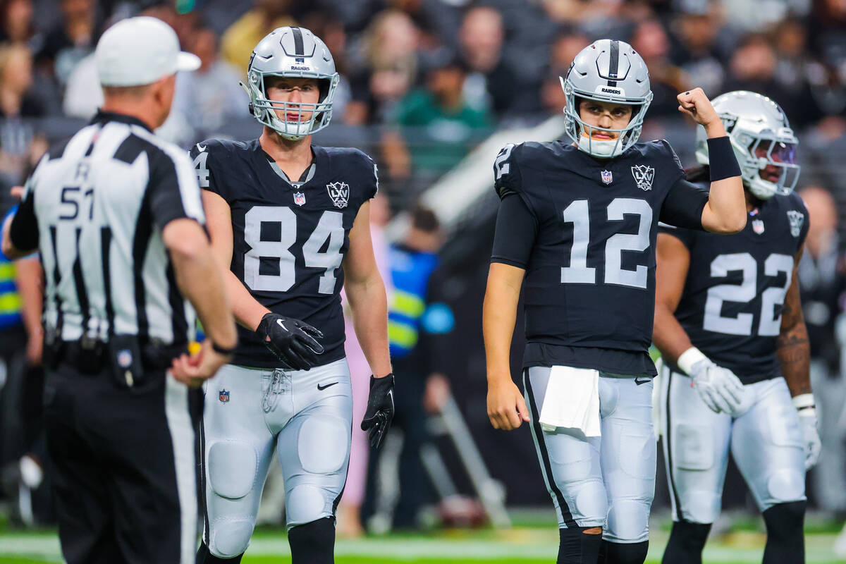 Raiders quarterback Aidan O'Connell (12) pumps his arm during an NFL football game between the ...