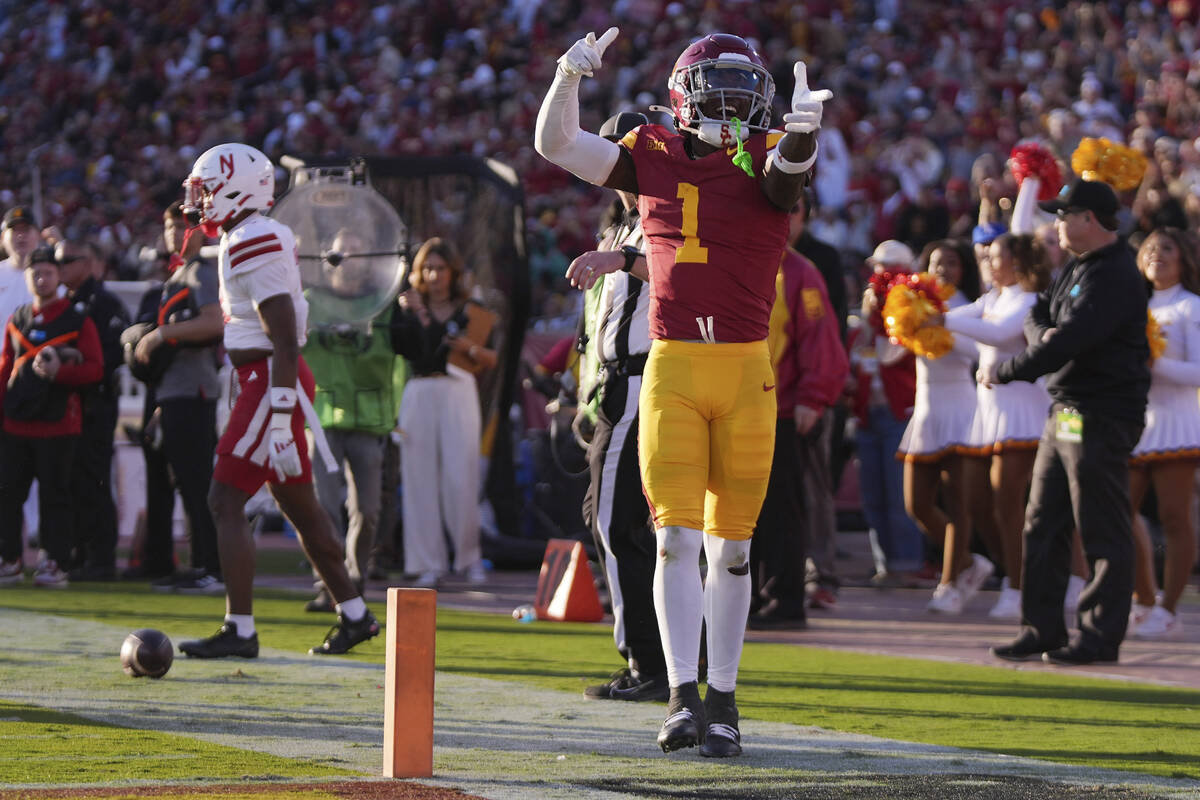 Southern California wide receiver Zachariah Branch, right, celebrates after coming up a few yar ...