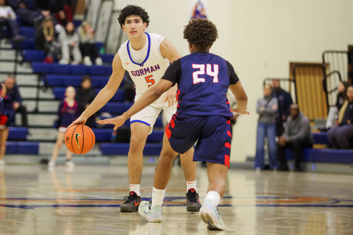 Bishop Gorman guard Dino Roberts (5) dribbles the ball during a basketball game between Liberty ...