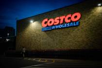 A person walks beneath the sign of the Pentagon City Costco Wholesale on Friday, May 12, 2023, ...