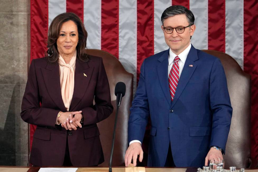 Vice President Kamala Harris stands with House Speaker Mike Johnson, R-La., as a joint session ...