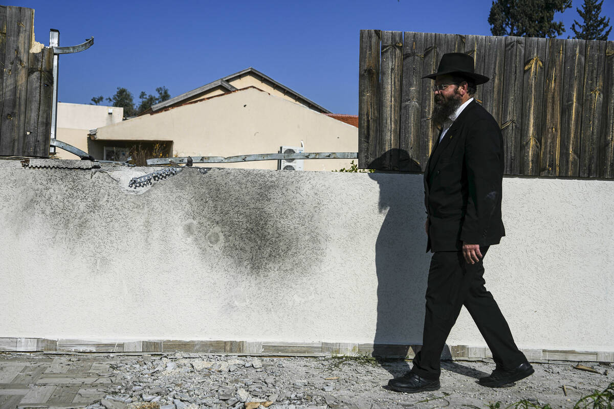 A man surveys a damaged home after a rocket fired by Palestinian terrorists from the Gaza Strip ...