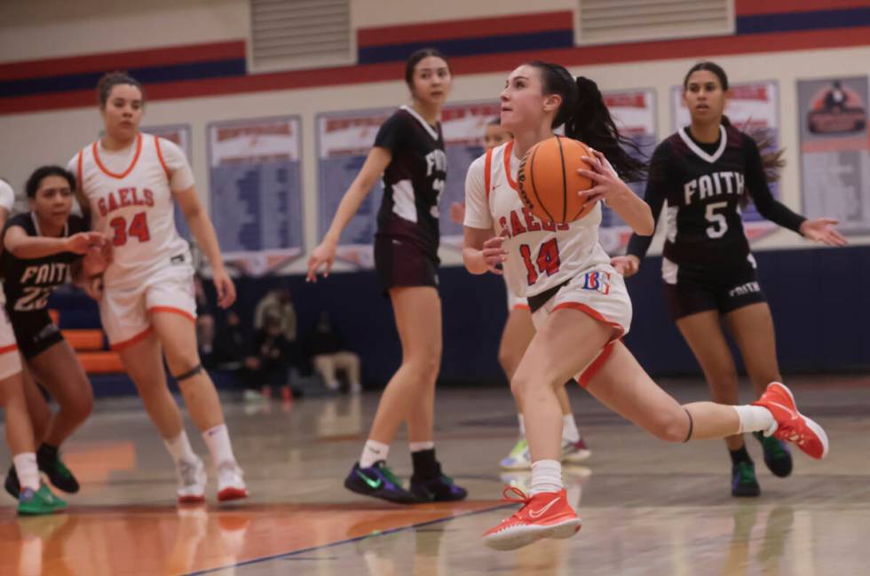 Bishop Gorman's Kenzee Holton (14) drives to the basket against Faith Lutheran during a high sc ...