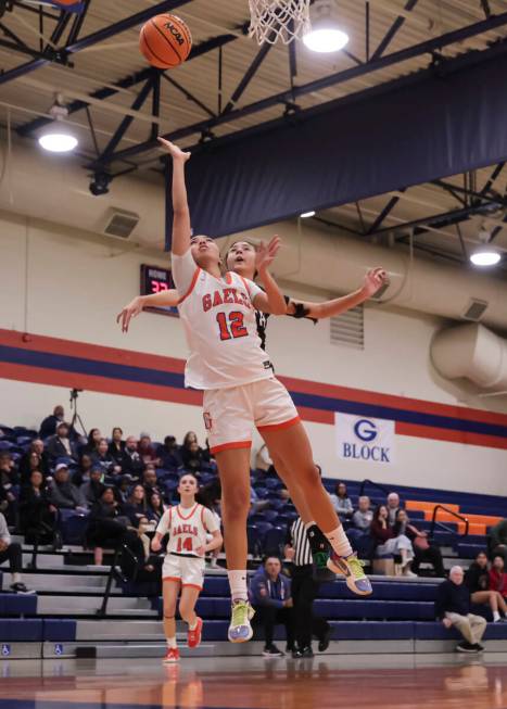 Bishop Gorman's Addysen Carr (12) lays up the ball against Faith Lutheran during a high school ...