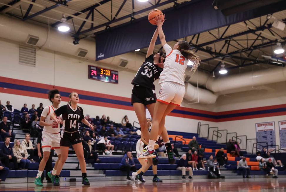 Faith Lutheran's Emma Herpin (33) and Bishop Gorman's Addysen Carr (12) battle for a rebound du ...