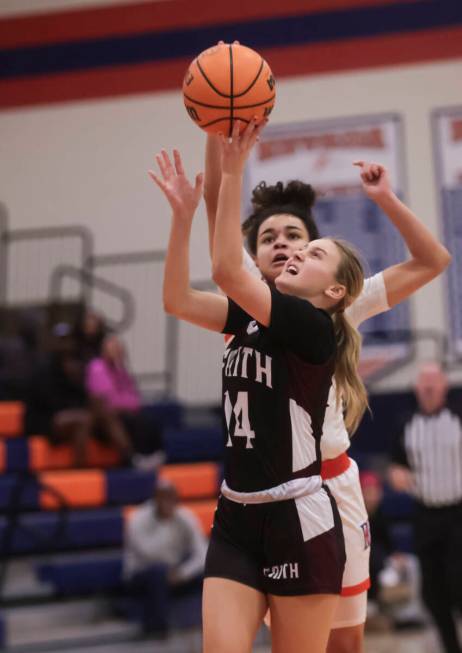 Faith Lutheran's Kloe Abdalla (14) shoots under pressure from Bishop Gorman's Aaliah Spaight (1 ...