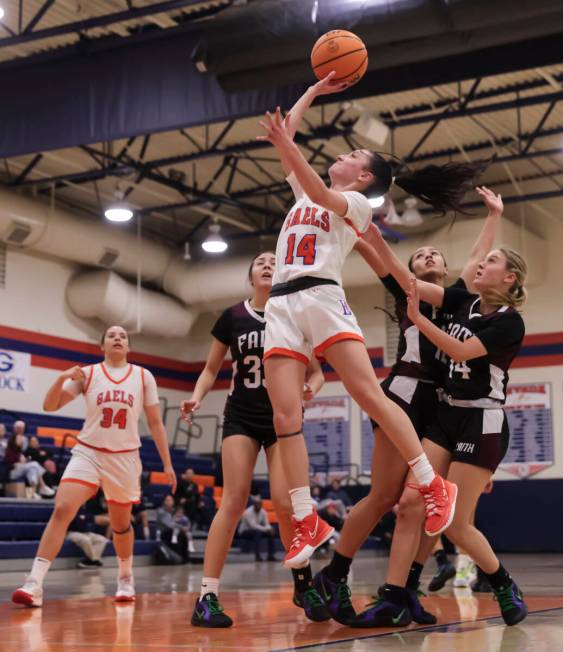 Bishop Gorman's Kenzee Holton (14) lays up the ball against Faith Lutheran during a high school ...