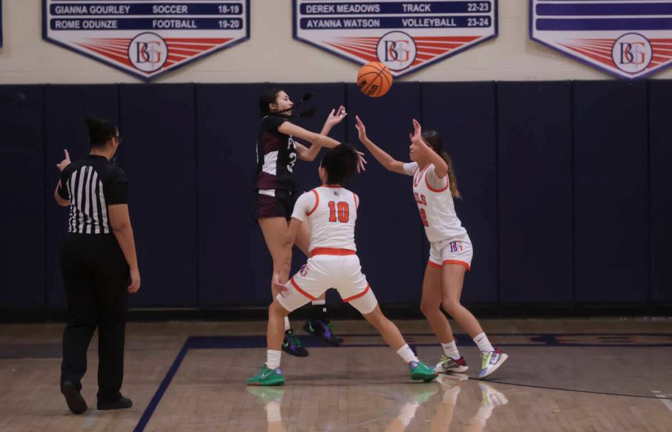 Faith Lutheran's Emma Herpin (33) passes the ball under pressure from Bishop Gorman's Aaliah Sp ...