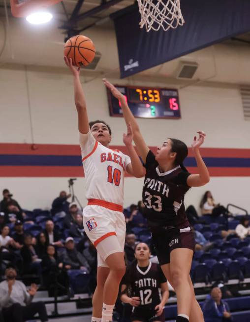 Bishop Gorman's Aaliah Spaight (10) shoots against Faith Lutheran's Emma Herpin (33) during a h ...