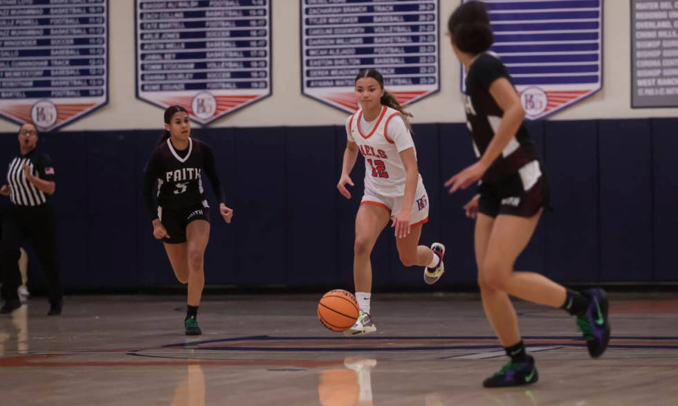 Bishop Gorman's Addysen Carr (12) brings the ball up court as Faith Lutheran's guard Caylyn Yo ...