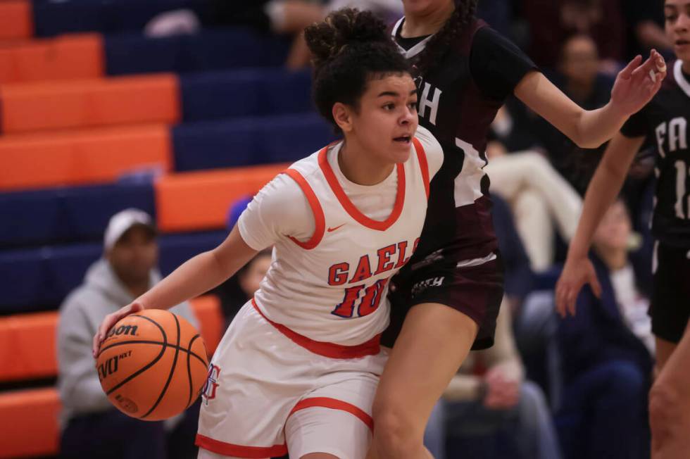 Bishop Gorman's Aaliah Spaight (10) drives the ball against Faith Lutheran's guard Emma Herpin ...