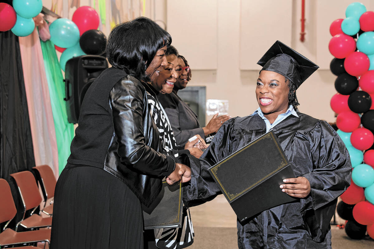 Myesha Young, an inmate at Florence McClure Women’s Correctional Center, receives her co ...