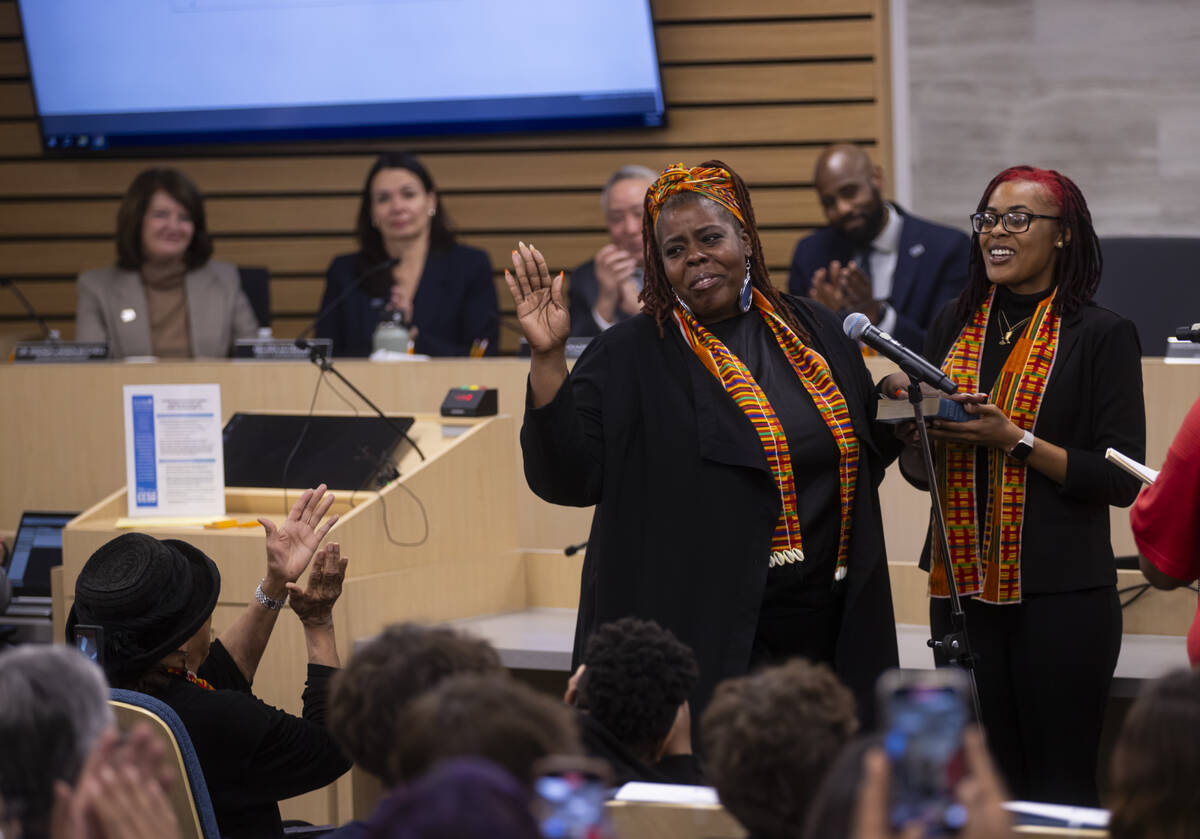 New Clark County School Board trustee Tameka Henry is sworn while standing next to her daughter ...