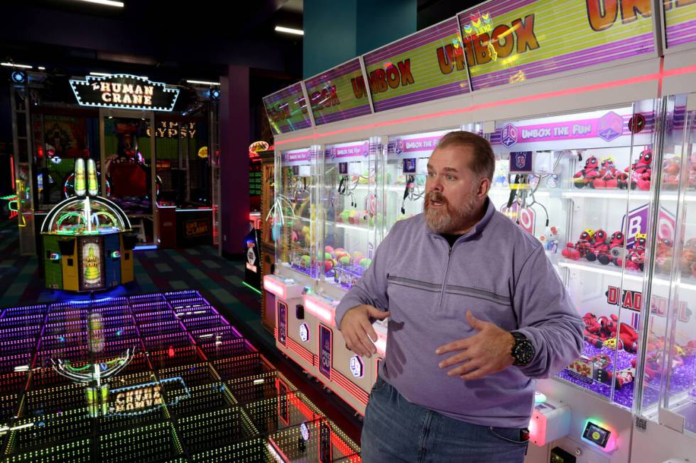 General Manager Chris Coley talks to a reporter about the opening-soon In The Game arcade busin ...