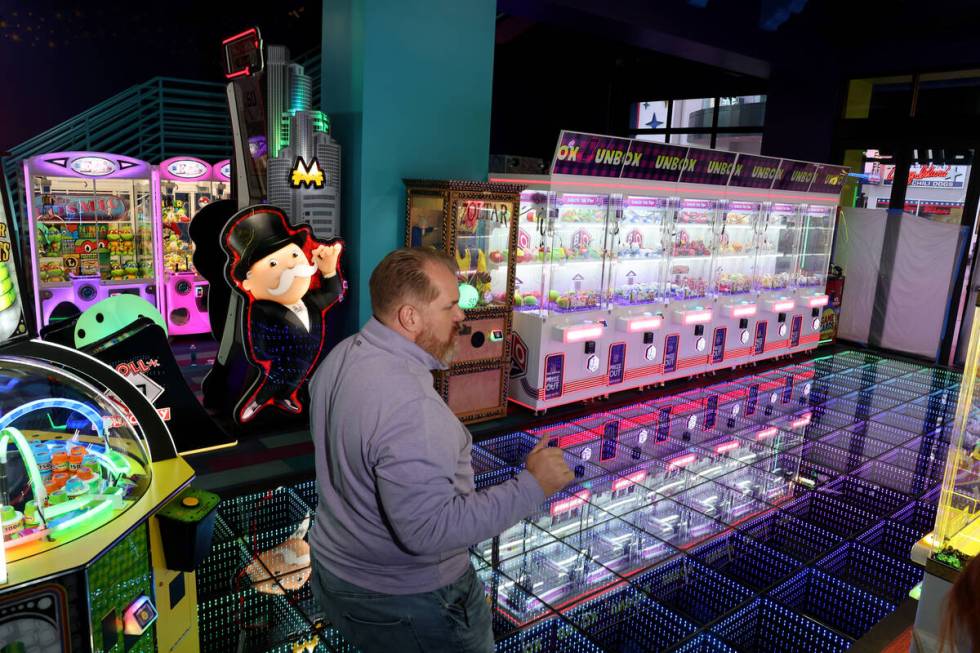 General Manager Chris Coley talks to a reporter about the opening-soon In The Game arcade busin ...