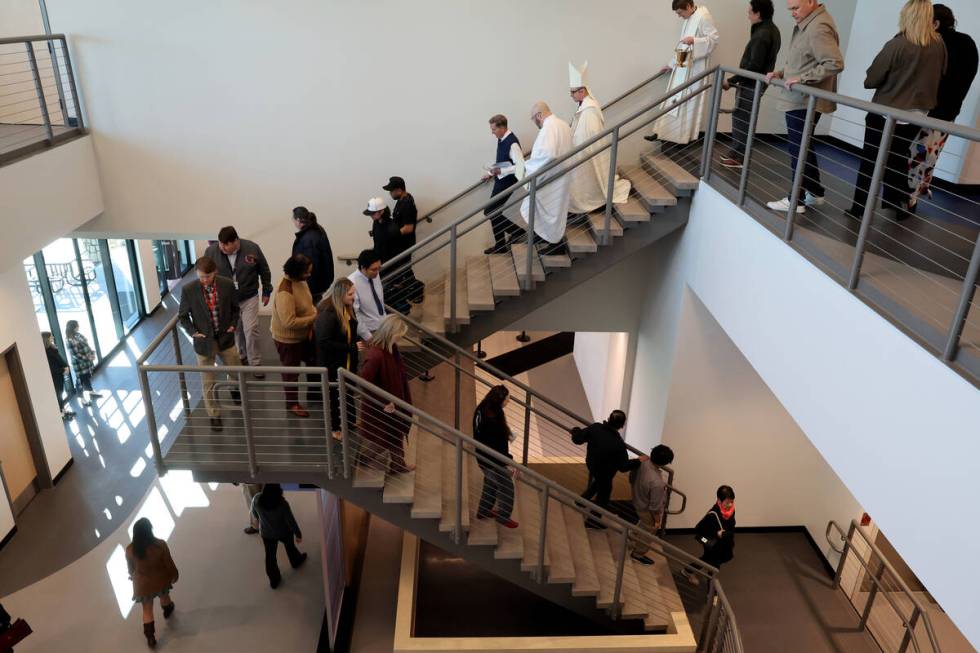 Clergy and guests walk through the new Gaughan Family Student Union at Bishop Gorman High Schoo ...