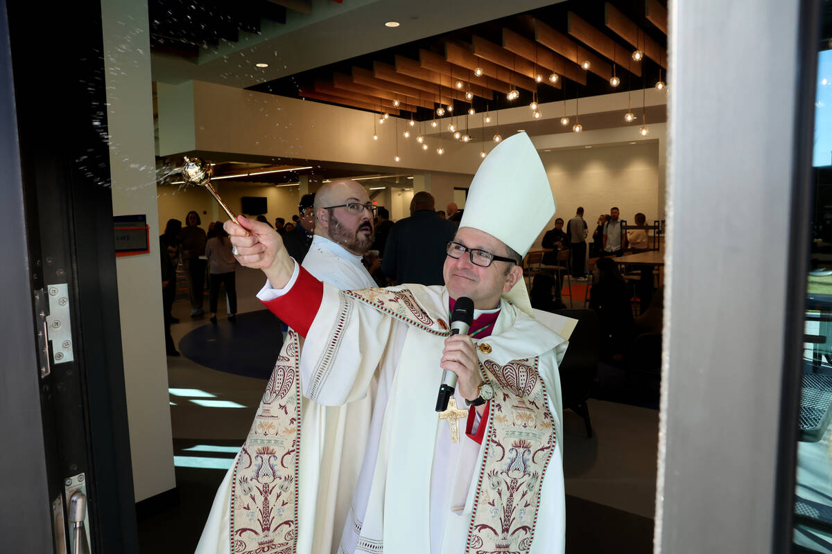 Bishop Greg Gordon, auxiliary bishop of the Archdiocese of Las Vegas, blesses the patio at the ...