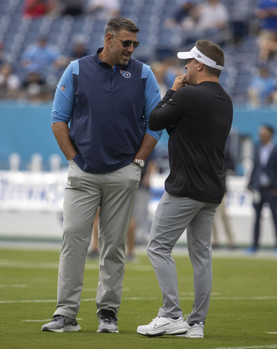 Tennessee Titans head coach Mike Vrabel, left, speaks to Raiders head coach Josh McDaniels befo ...