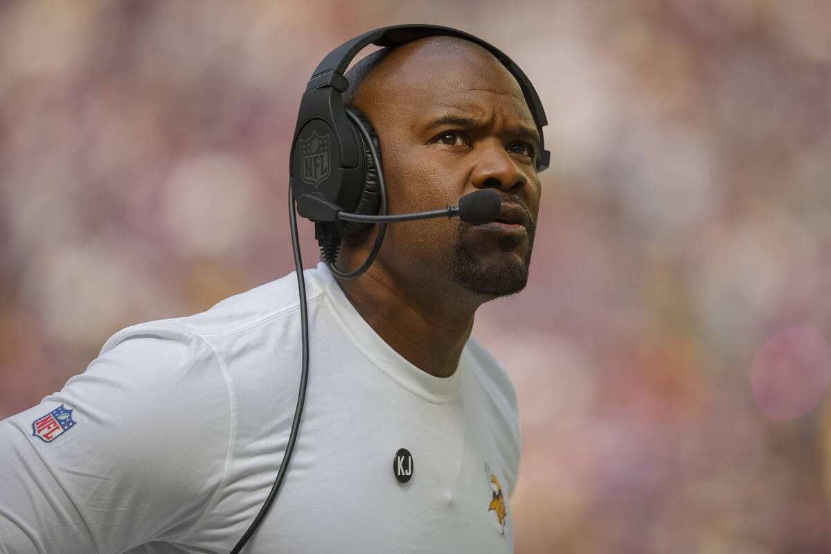 FILE - Minnesota Vikings Defensive coordinator Brian Flores looks to the scoreboard in the firs ...