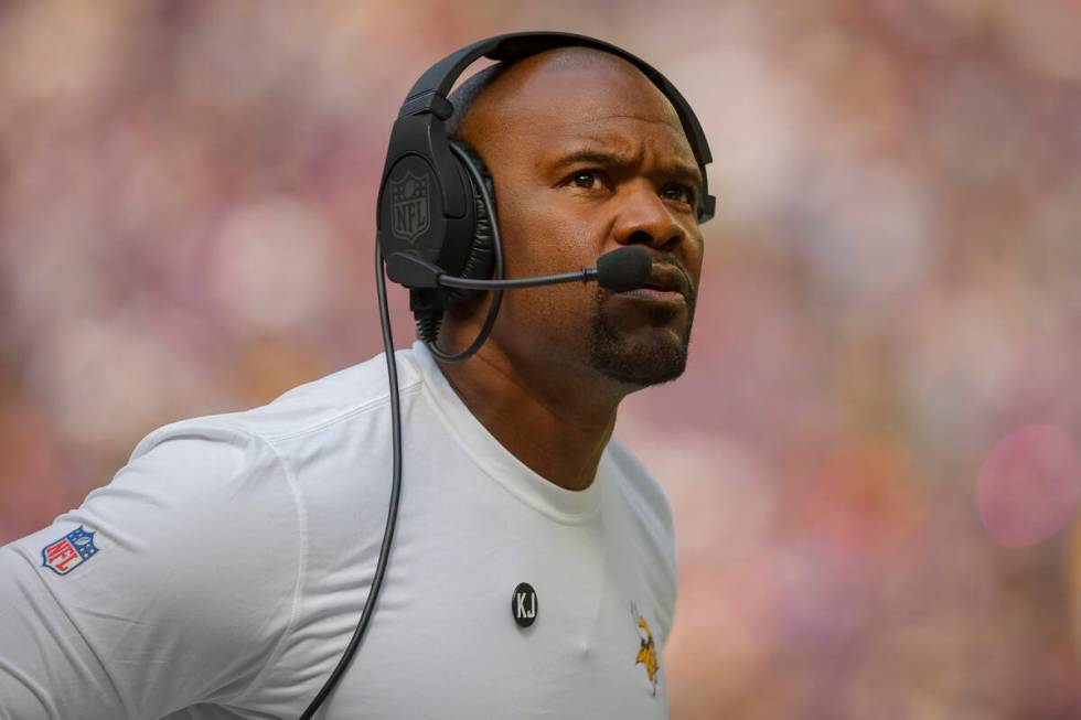 FILE - Minnesota Vikings Defensive coordinator Brian Flores looks to the scoreboard in the firs ...