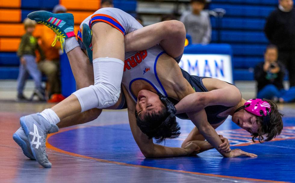 Bishop Gorman's Elijah Tabasa, left, is wrapped up by SLAM's Eric Bice on the mat during their ...