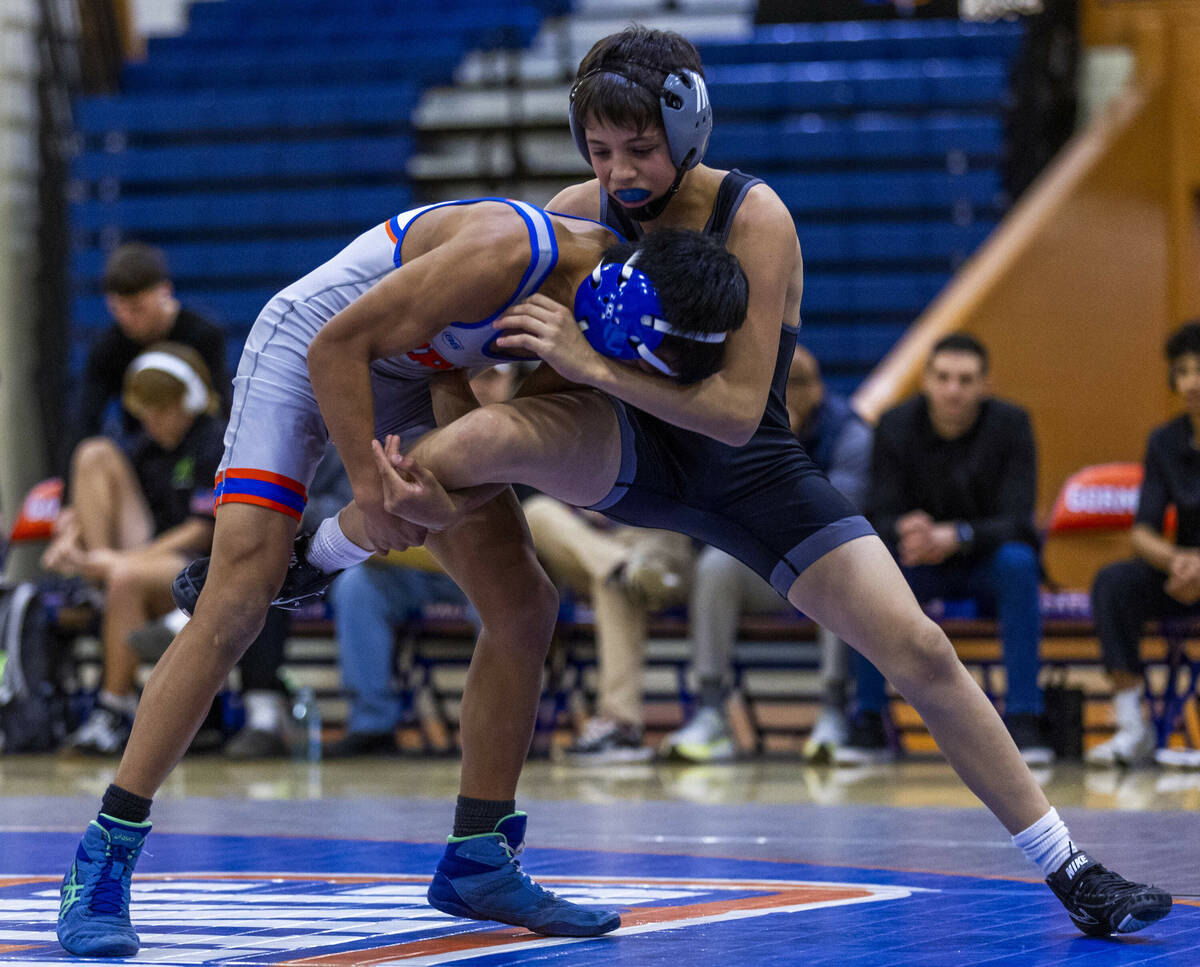 SLAM's William Bonwell, top, fights for control with Bishop Gorman's Connor Johns during their ...