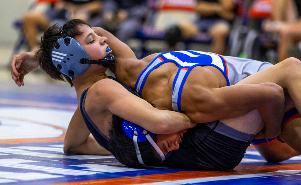 SLAM's William Bonwell, left, takes control over Bishop Gorman's Connor Johns during their 112 ...