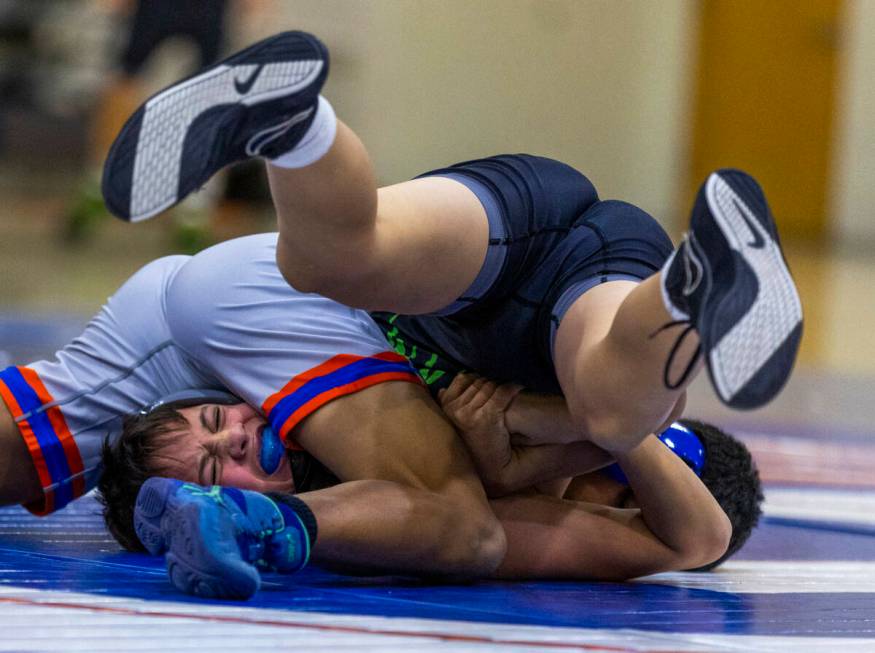 SLAM's William Bonwell, left, battles for control with Bishop Gorman's Connor Johns during thei ...