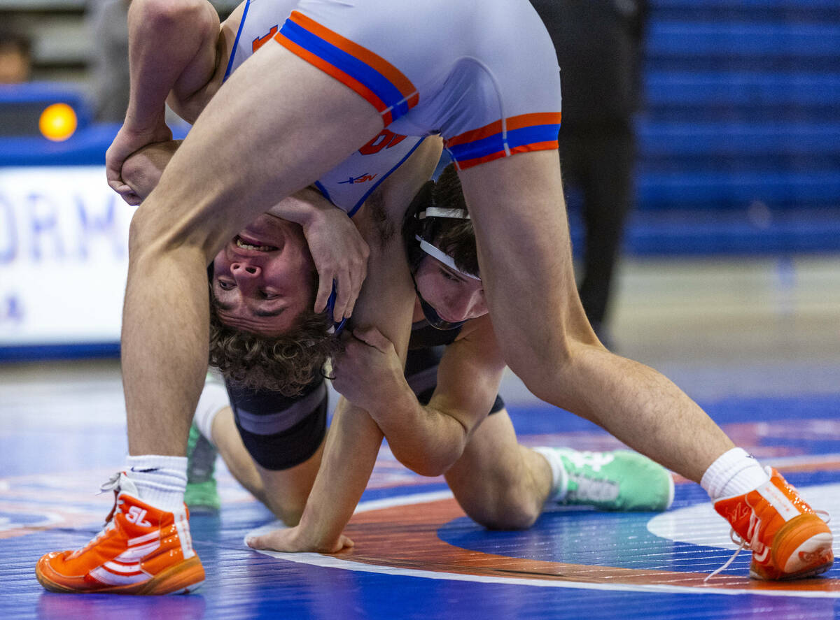 Bishop Gorman's Cash Hairston, left, is wrapped up by SLAM's Drake Hooiman during their 144 pou ...