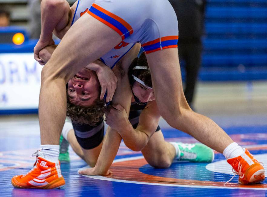 Bishop Gorman's Cash Hairston, left, is wrapped up by SLAM's Drake Hooiman during their 144 pou ...