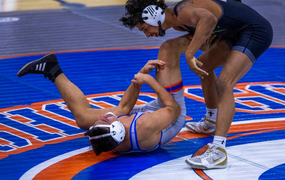 SLAM's Emilio Roybal, top, drives Bishop Gorman's Chance Leon-Guerrero down to the mat during t ...