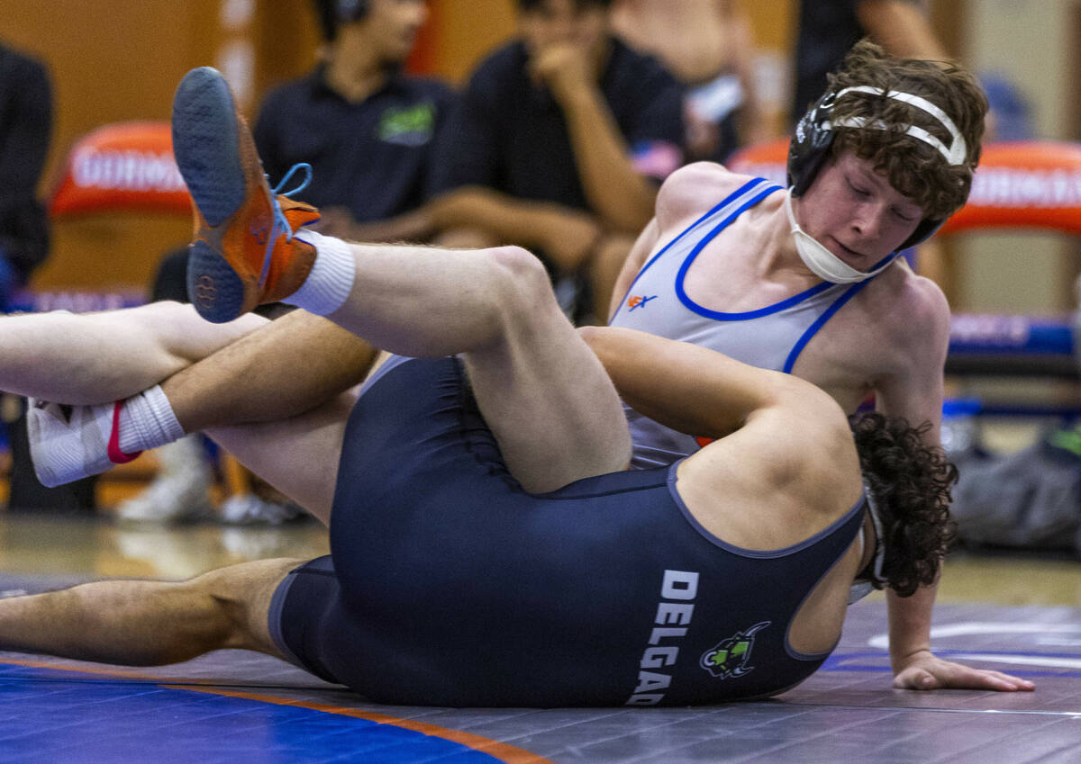 Bishop Gorman's Harrison Smith, top, is wrapped up with SLAM's Gabe Delgado during their 165 po ...