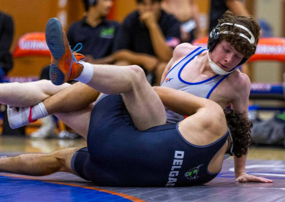 Bishop Gorman's Harrison Smith, top, is wrapped up with SLAM's Gabe Delgado during their 165 po ...