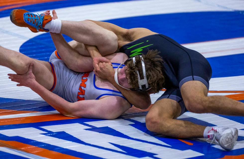 Bishop Gorman's Harrison Smith, front, is controlled by SLAM's Gabe Delgado during their 165 po ...