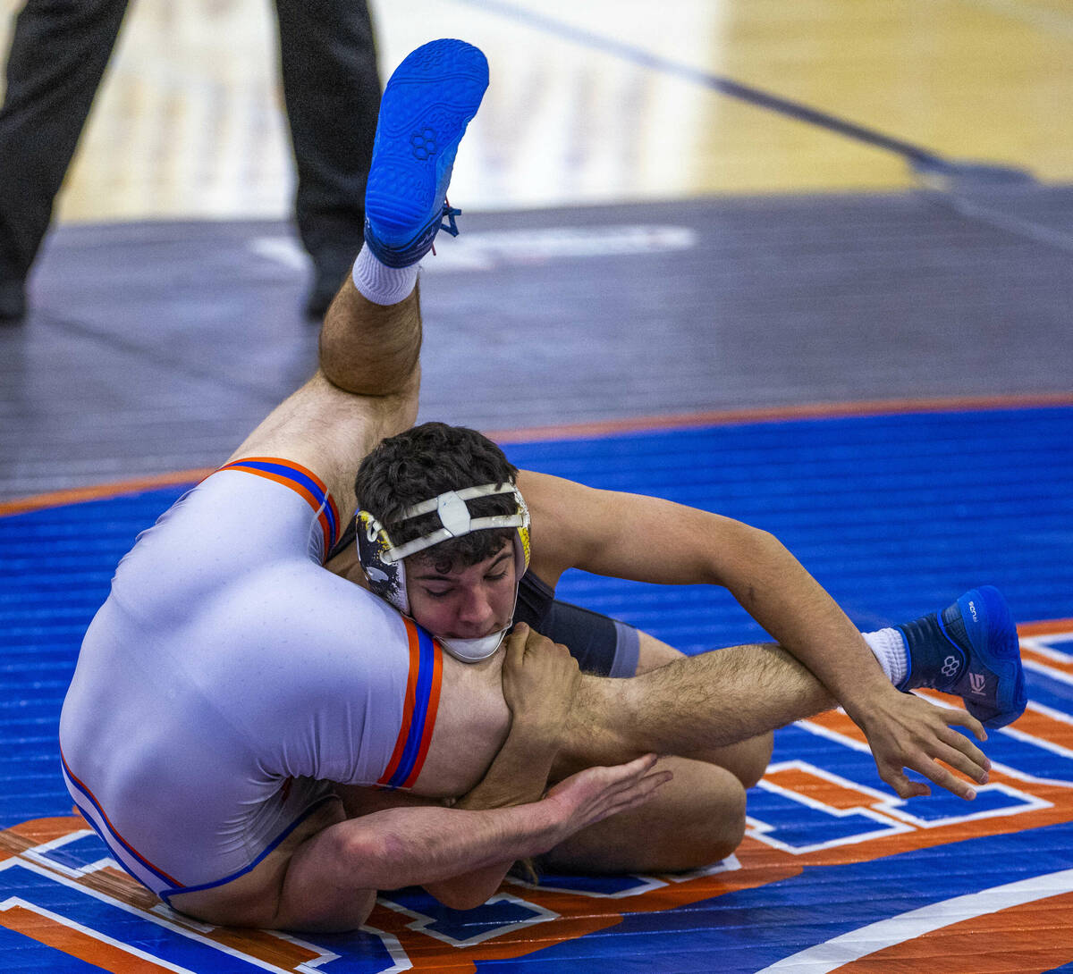 SLAM's Santiago Cabrera, front, works to pin Bishop Gorman's William Mueller during their 175 p ...